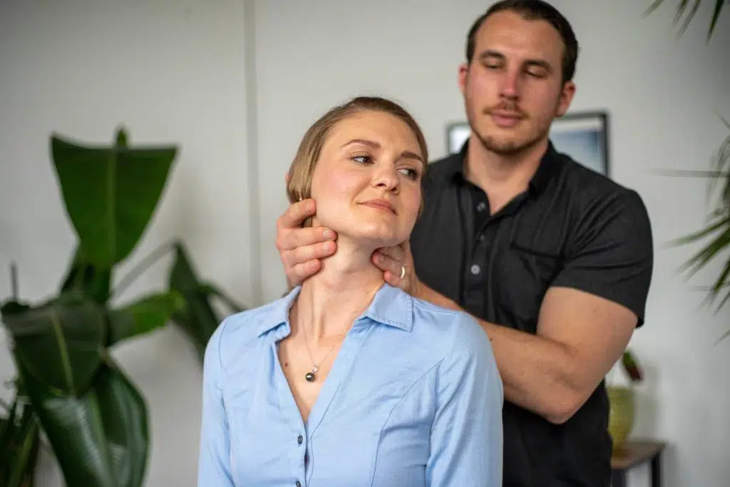 Chiropractor doing some chiropractic adjustment to the patient who suffers from whiplash