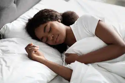 young black woman having a good quality sleep in bed