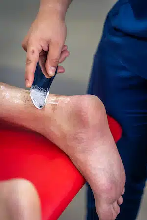 Instrument-Assisted Soft Tissue Mobilization IATSM therapy on a man's heel