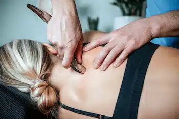 Woman receives a special medical back massage using an IATSM