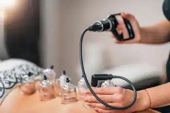 woman doing airsuction during cupping therapy
