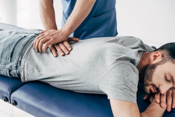 patient feeling relieved after chiropractor spinal adjustments