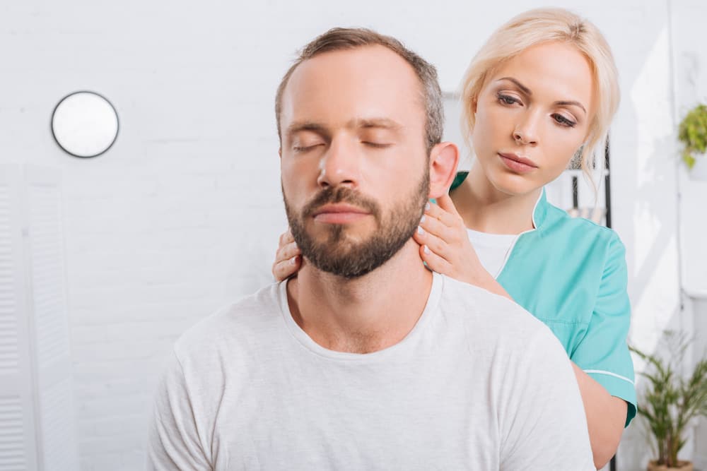 chiropractor performing neck massage for Chiropractic Care for Whiplash 