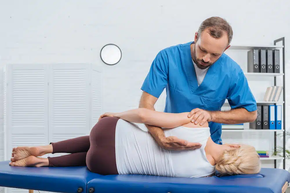 Vertebral and Extremity Manual Therapy performed to a patient experiencing back pain