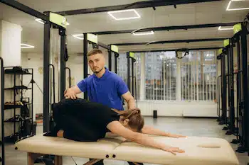 chiropractor helping patient perform exercises for personal injury recovery