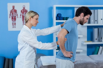 chiropractor examining-mans-back after getting into a car accident