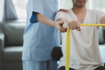 Doctor assisted the patient with neuromuscular reeducation