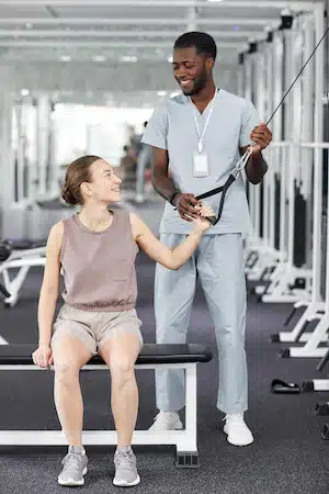 Doctor helping the woman for physical therapy exercises