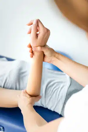 Experienced Chiropractor examining patient's wrist