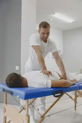 chiropractor doing hip adjustment on patient with hip pain