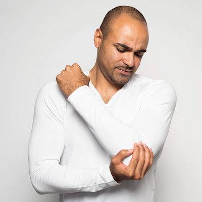 man holding his elbow from pain