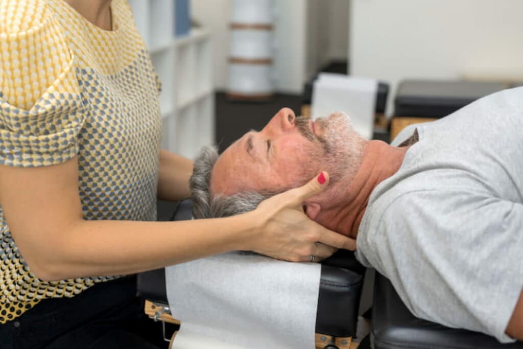 A man having a neck chiropractic