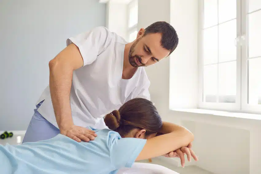 A young woman having a chiropractic