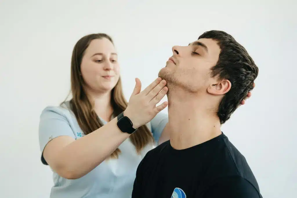 Physiotherapist Exercises with the Patient His Neck
