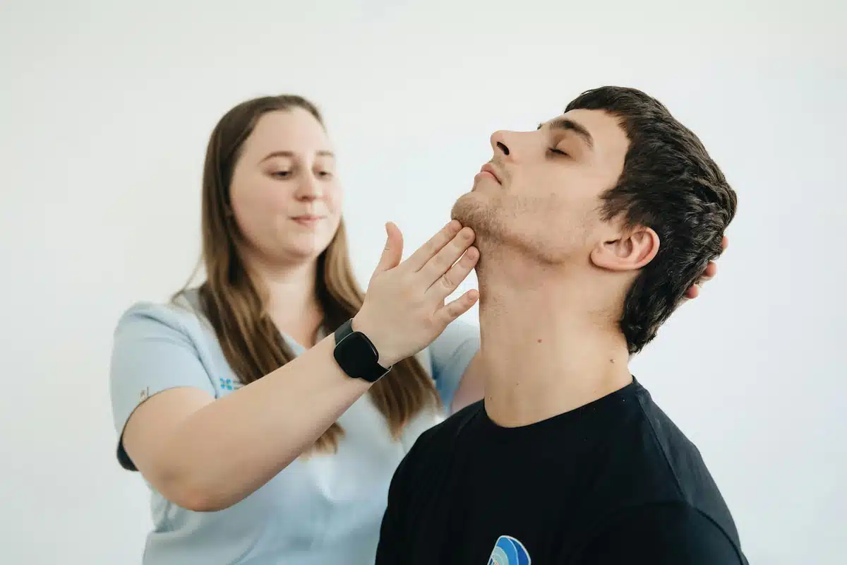 Physiotherapist Exercises with the Patient His Neck