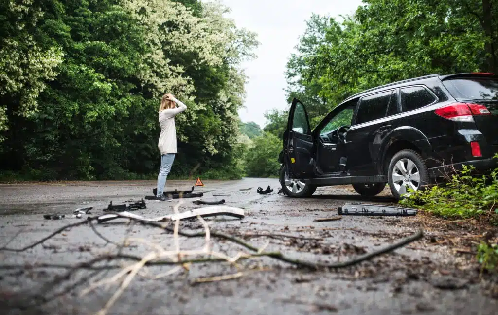 young woman standing experiencing a car accident