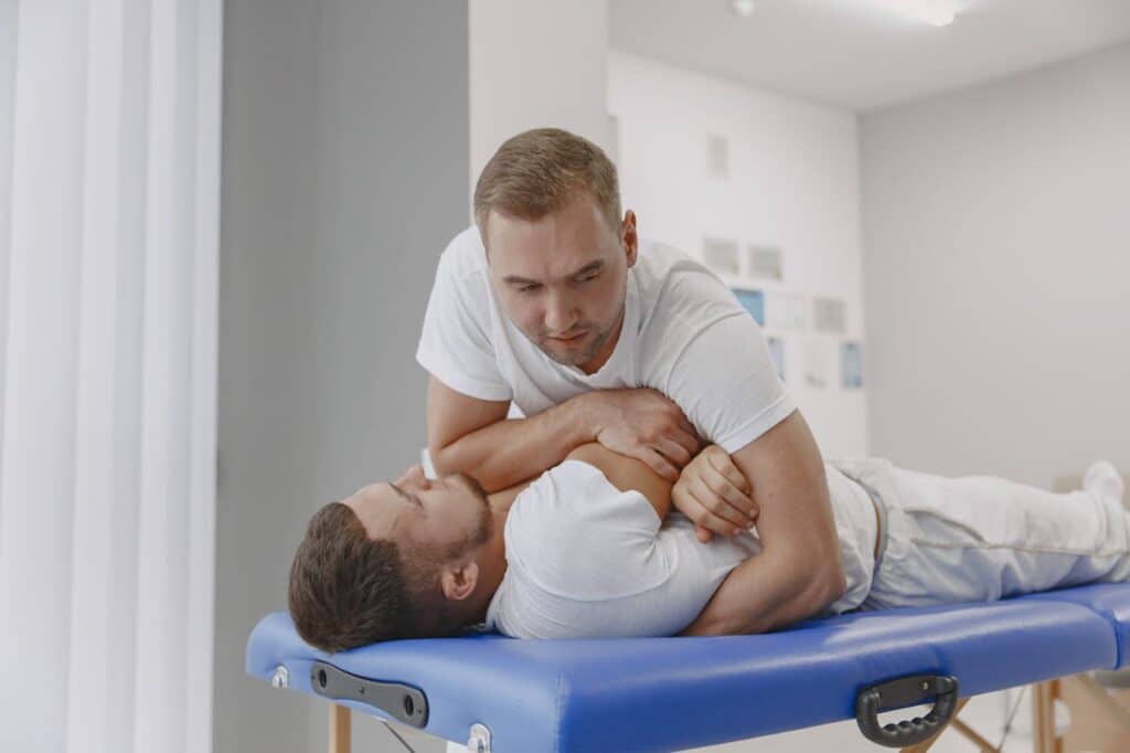 A licensed chiropractor in Burbank performing a professional manual spinal adjustment on a patient to relieve back pain and tension.