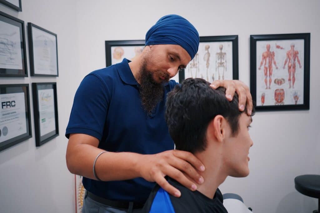 Chiropractor in Burbank performing a neck exam and adjustment for cervicogenic headache relief